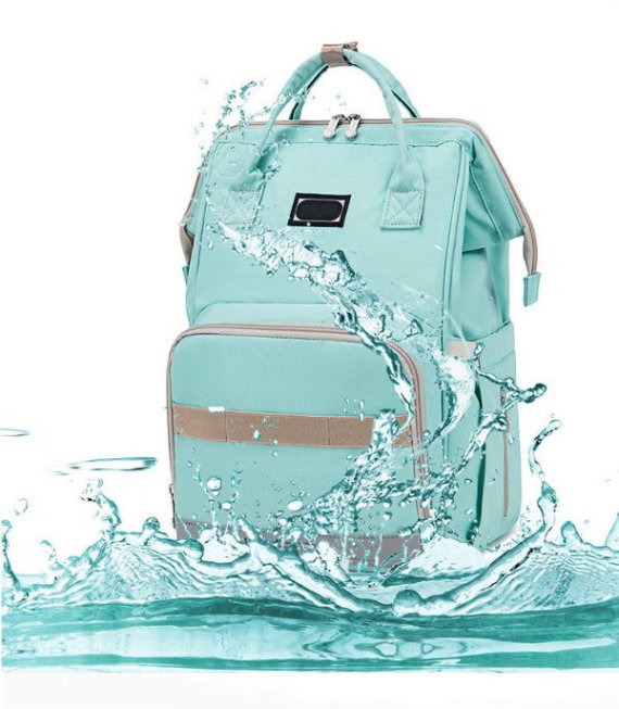 Front view of a stylish diaper bag with multiple compartments